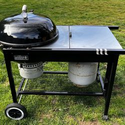 Webber Stainless Steel BBQ. With full size propane tank, and skillet add on, grill brush and charcoal bin!