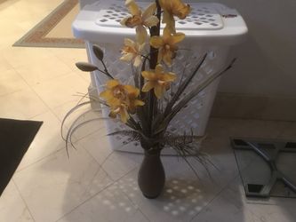 Brown vase with artificial flower arrangement