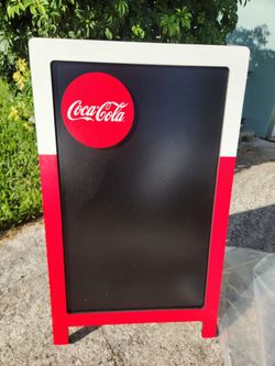 Coke sidewalk board.