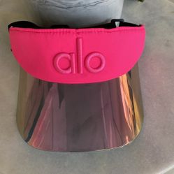 Alo Yoga Airlift Solar Visor in the Neon Bubblegum/Hot Pink color with a holographic brim