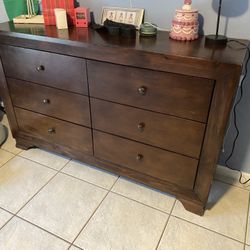 Brown wood dresser and nightstand