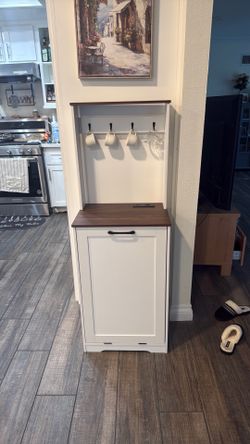 White cabinet with tilt trash bin