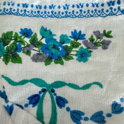 Vintage Tastemaker by Stevens fashion Terry  tablecloth 52“ x 70“. New in pkg unused. blue, turquoise and purple florals with greenery on a white back