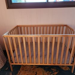 Wooden crib with mattress