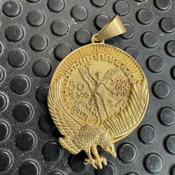 Mexican Centenario "50 Pesosp" coin pendant, frequently featured in gold-plated versions.