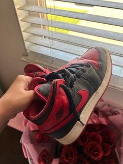 Nike Air Jordan 1 Mid sneakers in the "Bred" or "Banned"