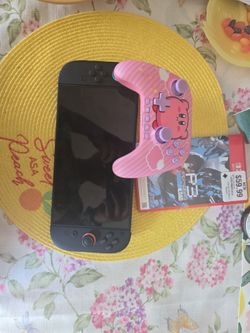Switch 2 console with Kirby controller, and persona 3 game, and Kirby game