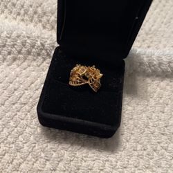 There is a gold over silver ring missing one stone