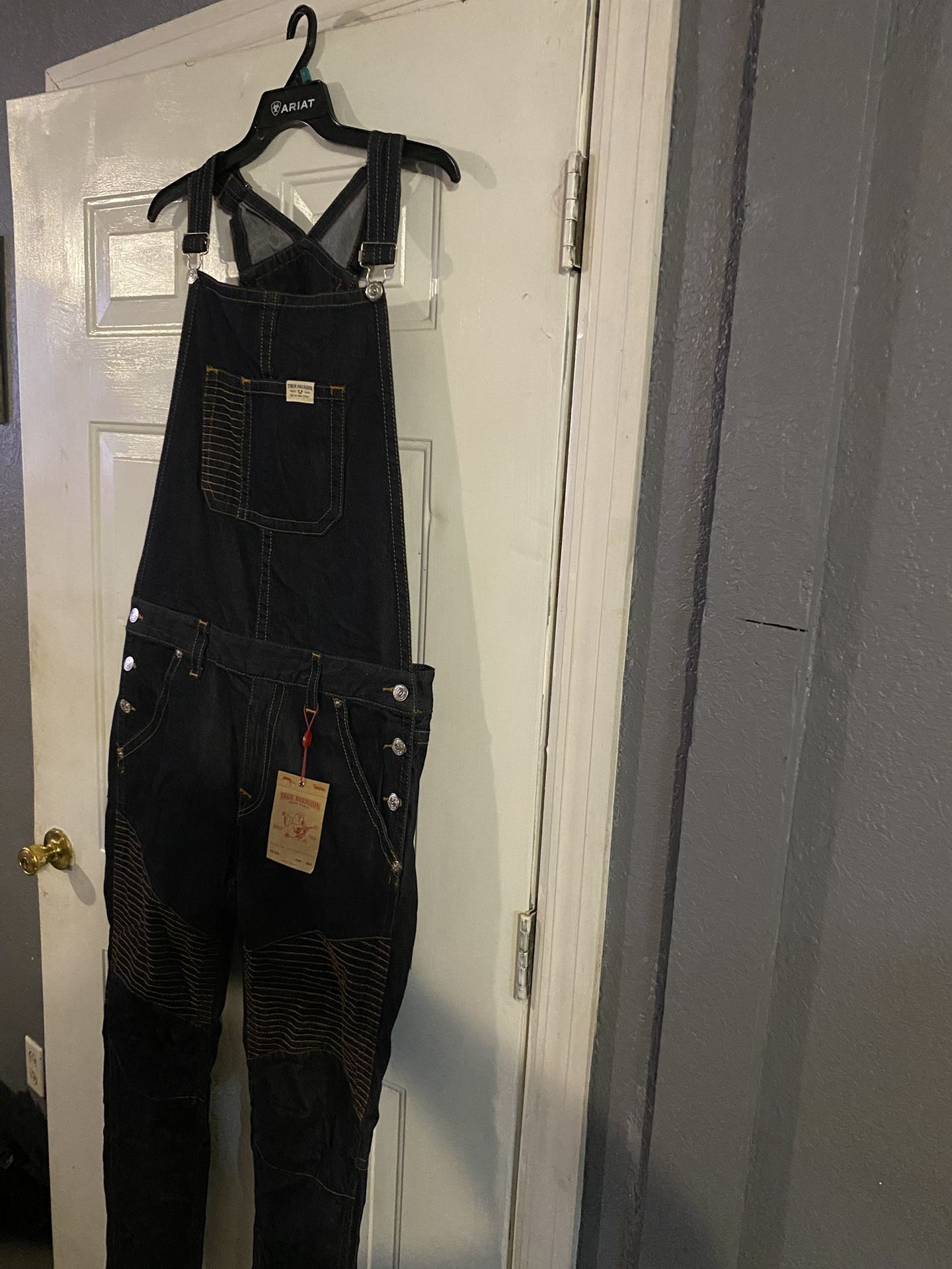 Dark blue denim overalls with front pocket and button details. $120 Location Mount Dora Fla 32757