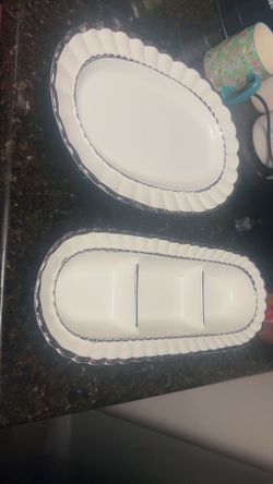 Two white stand dishes and white teapot with 4 cups