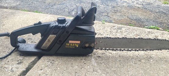 Chain saw cutting wood