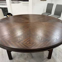 Beautiful 72-inch (6 ft) round wood dining table in excellent, like-new condition. Features a striking chevron-pattern tabletop with rich dark mahogan