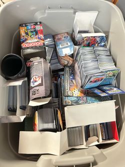 Two boxes of base pokemon and sports