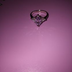.925 sterling silver ring  
Light lilac (purple) Diamond Shape center rinestone 
2 clear white rhinestones