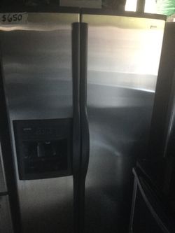 Kenmore Stainless and black side by side refrigerator/ one year warranty/ delivery and installation are available