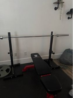 Bench with bar and full set of weights.