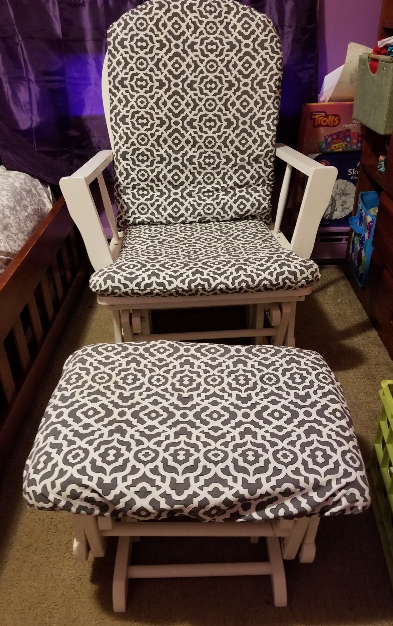 White wooden gray & white padded rocking chair.