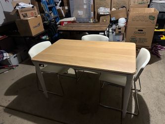 Table with 3 white chairs