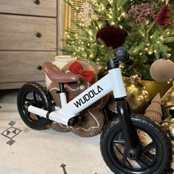 Balance bike for children aged 2 to 5 years, available in dark green and white.