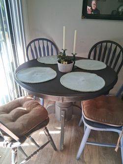 Round black wooden table with chairs
