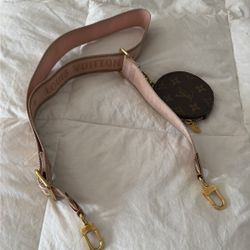 Louis Vuitton Monogram round coin purse attached to a pink embroidered strap 
