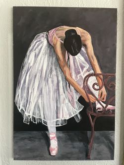 Ballerina tying pointe shoe
