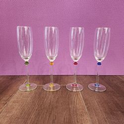 4 long-stemmed champagne flutes, textured optic bowls, delicate multicolored accent beads on the stems in green, yellow, red, and blue, great conditio