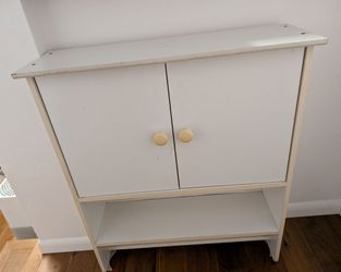 White storage cabinet with towel rack