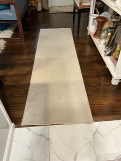 An alway 85” x 24” beige rug