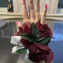 Handmade Corsage Wristlet Burgundy Roses Green Leaves Gorgeous corsage, lifelike roses, great color combo Has an interesting feature one small dried f