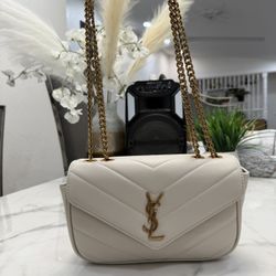 Saint Laurent Loulou bag in white quilted leather with a gold-toned YSL logo and chain strap. 