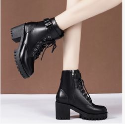 women's black chunky-heeled combat boots with a lace-up front, side zipper, and buckle strap. 