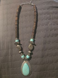 Southwestern-style statement necklace featuring a large turquoise color teardrop pendant
