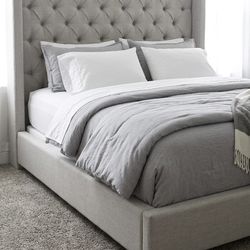 upholstered bed frame with mattress.