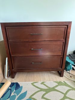 Three drawer dark brown dresser.