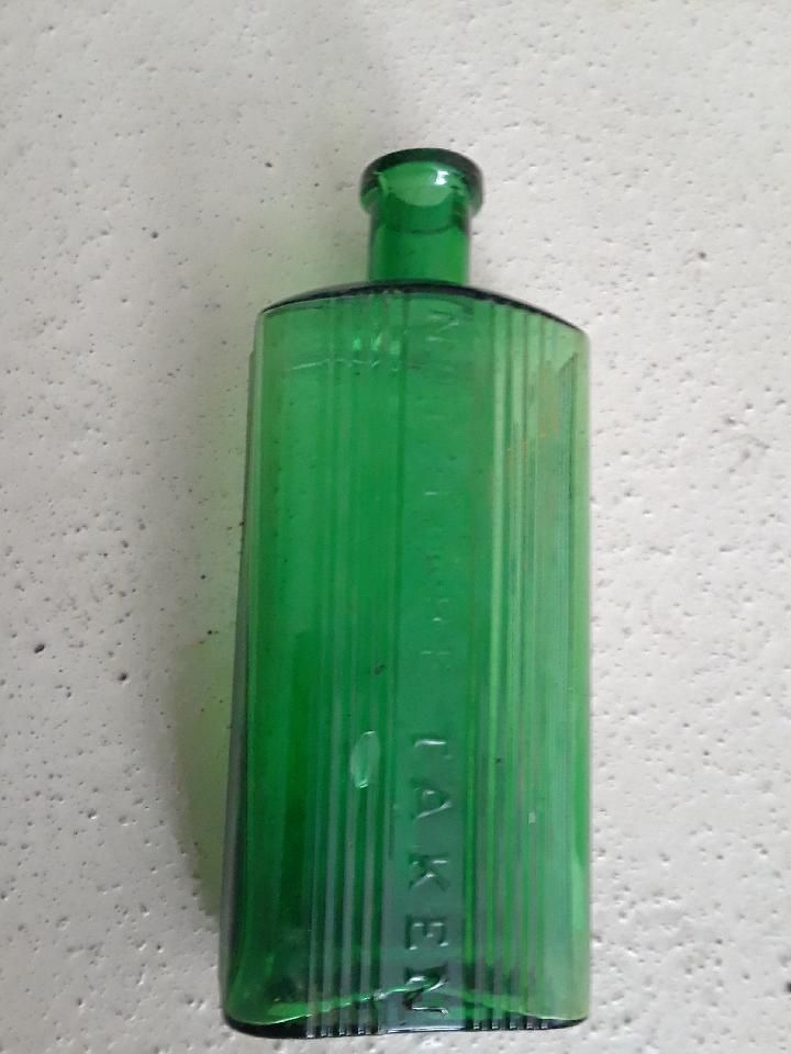 Vintage bottle. Vintage Green pharmacy bottle reads NOT TO BE TAKEN. 6.75 inch tall.