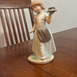 Porcelain Girl Holding A Cake 