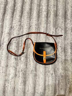 Dooney & Bourke black leather crossbody bag orange trim