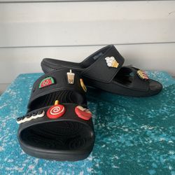 Solid black crocs sandals with charms