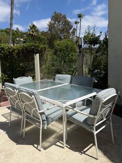 FREE Outdoor metal/glass top dining table w/8 cushion chairs; rust as shown