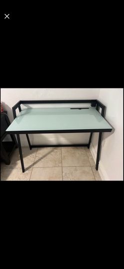 black office desk with a sturdy glass top