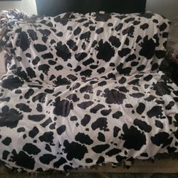 Soft Full XL fleece tie blanket with cow print pattern on one side and a solid brown color on the reverse.