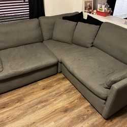 Three piece sectional couch with five pillows