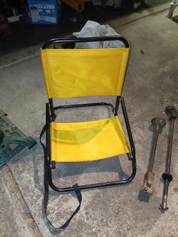 Folding low to the ground camping or beach sand chair with carrying strap