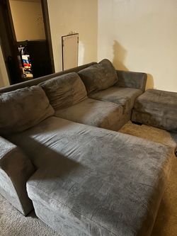 Grey couch with chaise and ottoman