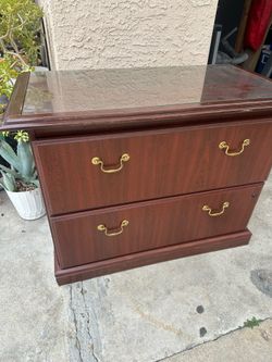 Dark wood filing cabinet with glass top, 2 drawers