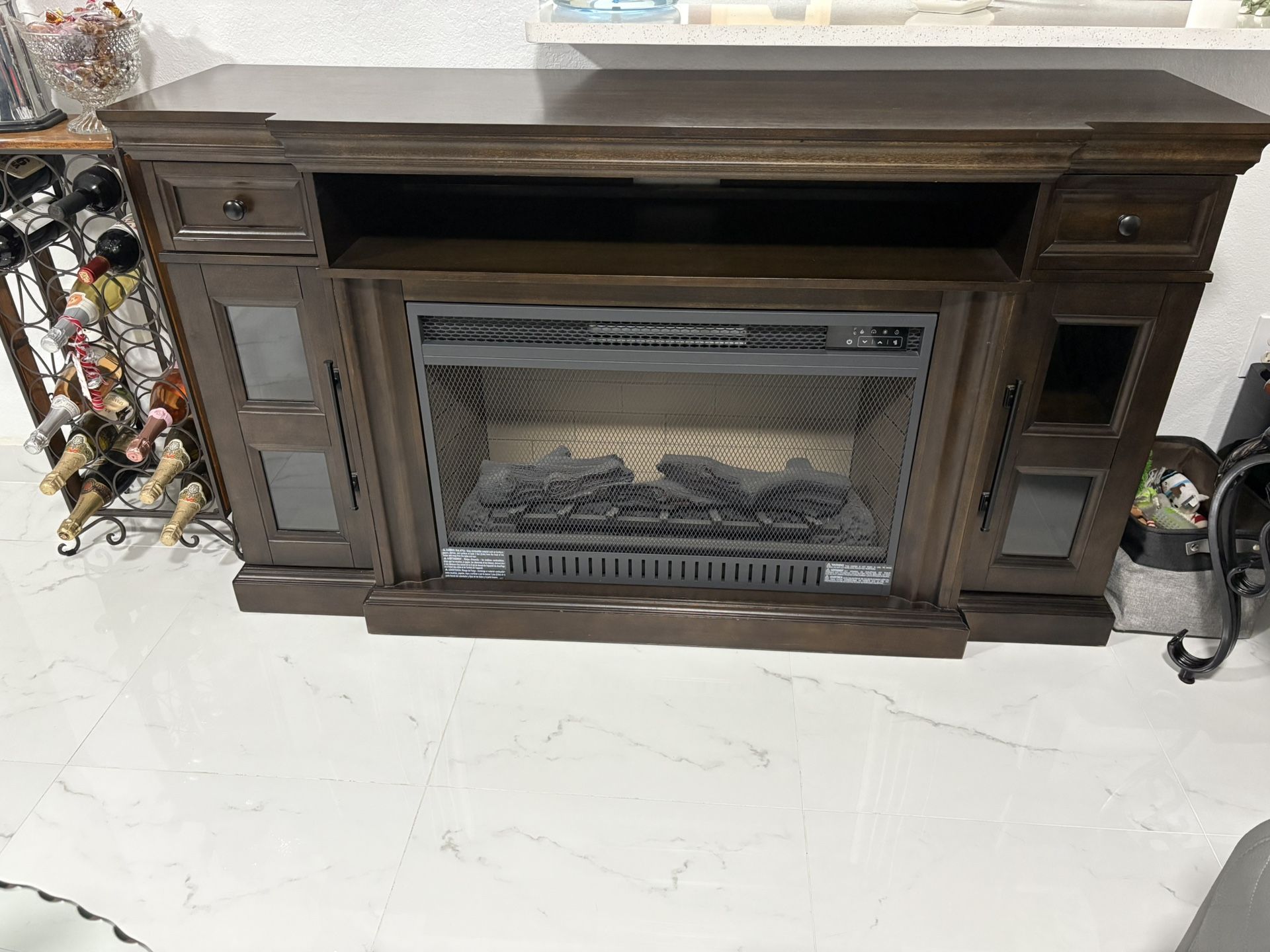 “I’m selling an electric fireplace, a coffee table, a side table, and a wine rack.”