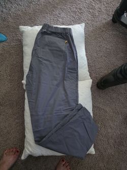grey scrub pants is from the WonderWink "Origins" series, recognizable by the signature small yellow square tag on the corner of the back pocket . Gra