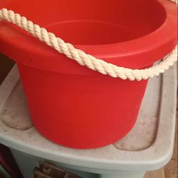 A  Red Bucket W/ A Rope Handle 