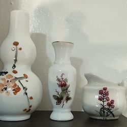 Three Small Porcelain Vases with Flowers.